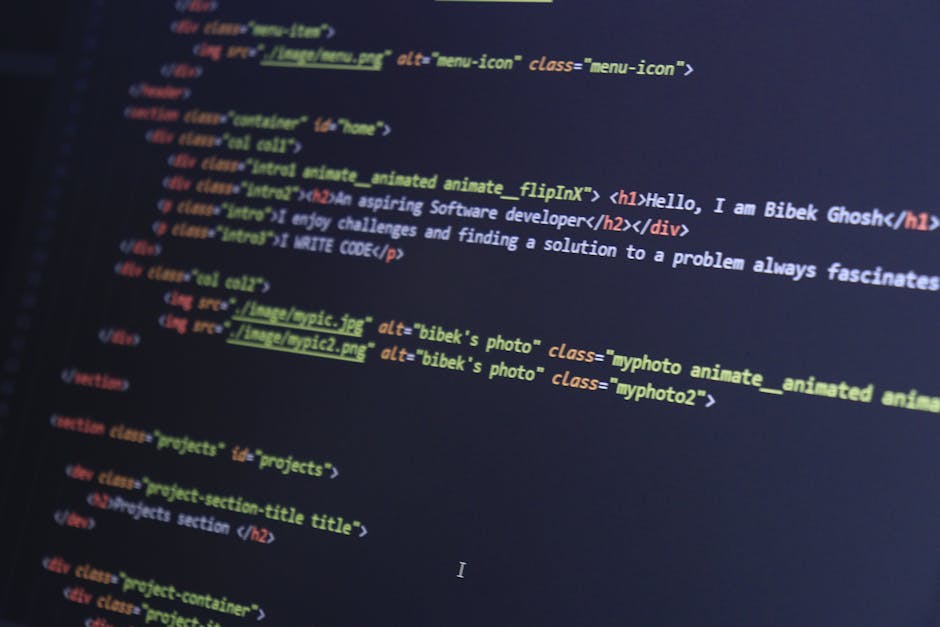 A close-up view of a computer screen displaying lines of HTML code with syntax highlighting in various colors, including blue, green, yellow, and red. The code includes tags like <h1>, <div>, and <img